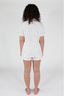 A woman wearing a white short sleeve and short pajama set with text and confetti print
