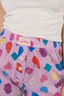 Up close photo of purple shorts with multicolor pattern.