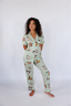 Model standing in sage green pajamas with duck print.