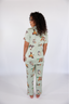 Model standing in sage green pajamas with duck print.