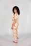 Woman wearing a patterned pajama set on a white background