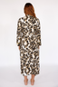 Woman wearing a luxury leopard print long robe with lime punch piping on a white background
