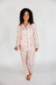 Woman wearing a patterned pajama set on a white background
