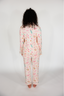 Person wearing a floral pajama set on a plain background