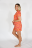 Woman wearing a colorful patterned outfit on a white background
