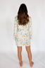 Person wearing a floral nightshirt on a white background