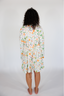Person wearing a floral dress on a white background