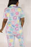 Model showing light blue pajama set with multicolored cake pattern.