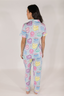 Model showing matching light blue pajama set with multicolored cake pattern.