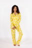 Woman wearing yellow star-patterned pajamas on a white background