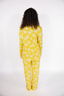 Person wearing a yellow star-patterned onesie on a white background