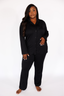 Woman wearing black luxury pajamas on a white background