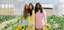 Three women standing in a greenhouse holding flowers wearing soft, modal, luxury pajama sets.