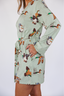 Model standing in short robe that is green with ducks.