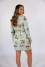 Model standing in short robe that is green with ducks.