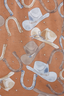 Up close photo of brown pajama with hat and horseshoe icons.