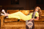 Woman in a luxury pajama set lying on a brown couch with a 'High Frequency' record
