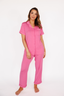 Woman wearing pink pajamas on a white background