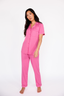 Woman wearing a pink pajama set on a white background