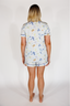 Person wearing a patterned pajama set on a white background