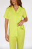 Woman wearing a lime punch green luxury pajama set on a white background