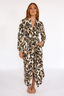 Woman wearing a luxury leopard print long robe with lime punch piping on a white background