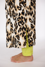 Woman wearing a luxury leopard print long robe with lime punch piping on a white background