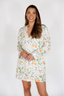 Woman wearing a floral patterned robe on a white background