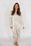 Woman wearing a floral pajama set on a white background