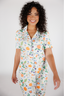 Woman wearing a colorful fruit-patterned pajama on a white background