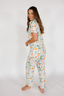 Woman wearing a fruit pajama set on a white background
