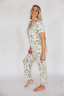Woman wearing a fruit pajama set on a white background