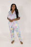Model in light blue matching pajama set with multicolored cake pattern. 